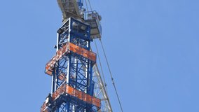 Construction crane shaft on a blue sky for copyspace 4k uhd