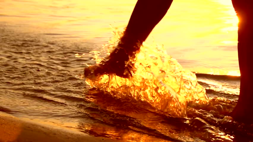 girl walking on beach at sunset