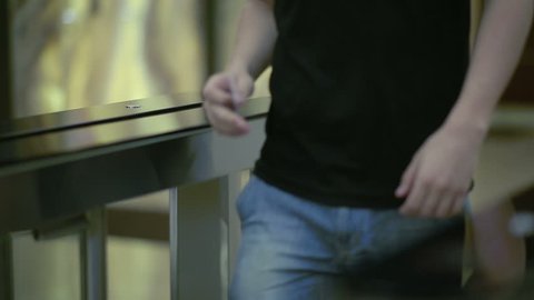 People pass through a turnstile with electronic access card