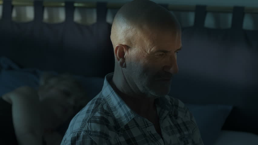 mad man in the darkness is thinking to kill a woman with a knife