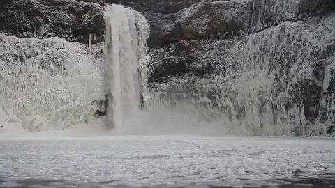 Water falls 200 feet to the icy pool below during a cold spell in the Pacific Northwest