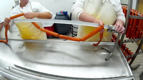 Factory for production of sausages; Slaughterhouse meat industry-stringing freshly made sausage,video clip