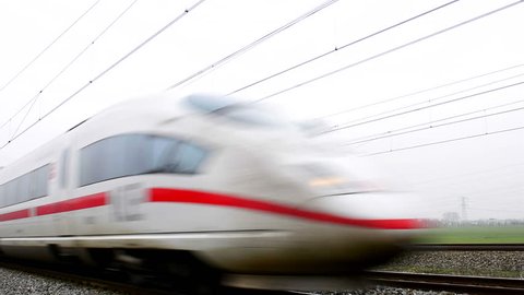 BREUKELEN, THE NETHERLANDS - DECEMBER 6, 2014: German high speed ICE train (Intercity-Express) driving at high speed on a railroad track in the countryside.