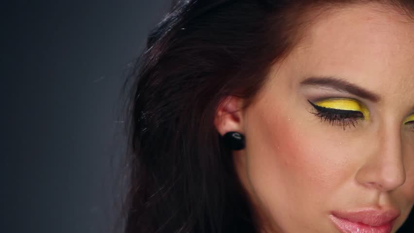 Sexy brunette in outstanding yellow makeup