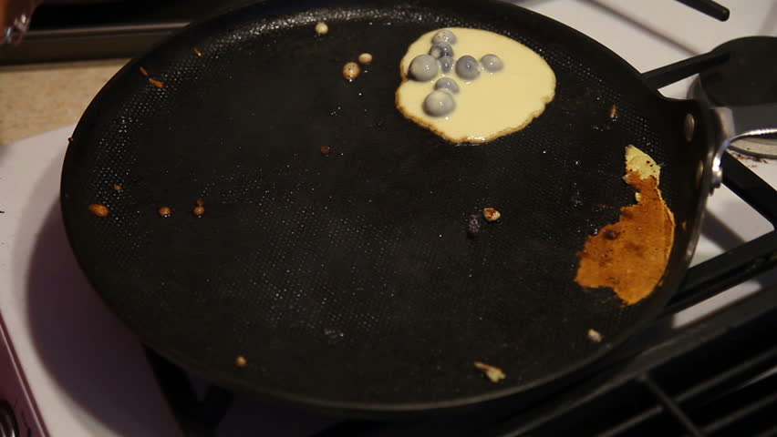 Making blueberry pancakes.