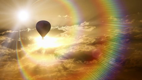 Hot air balloon traveling through spectrum of colorful rays at sunset.