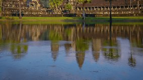 Video UHD - Slow. upward tilting shot of Angkor Wat Temple in Siem Reap. Cambodia. The panoramic view in time-lapse shows tourists and traffic.