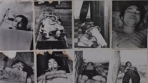 PHNOM PENH, CAMBODIA - JANUARY 13, 2014: Photos of dead victims of the Khmer Rouge on display at the Tuol Sleng Genocide Museum (aka S21) in Phnom Penh, Cambodia.