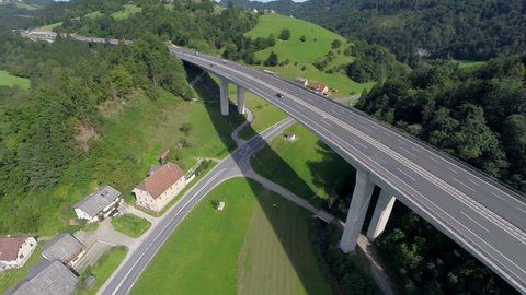 Big bridge of a highway in a nataure. Aerial shoot of a big bridge of highway road in a nature with traffic of cars and trucks