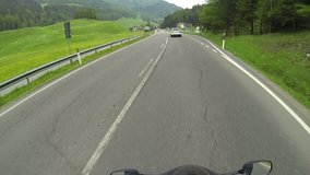 A motorcycle winds their way through Switzerland. A tour of European villages and mountain passes