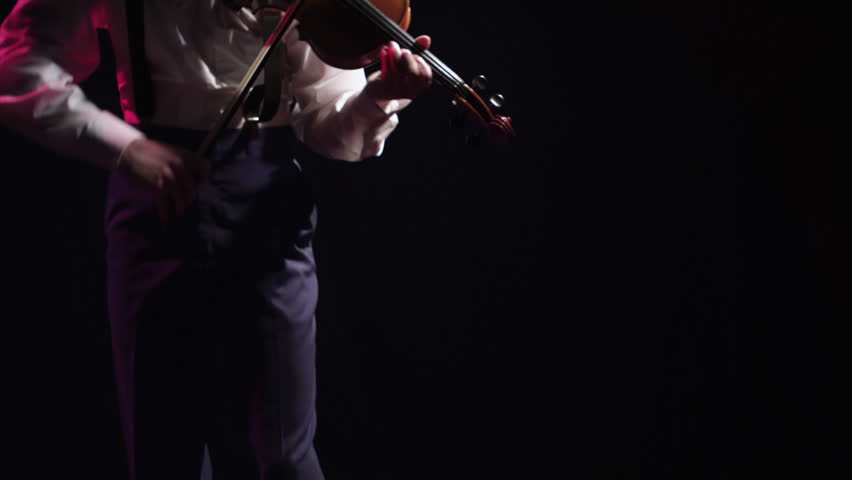 A young violinist playing his instrument