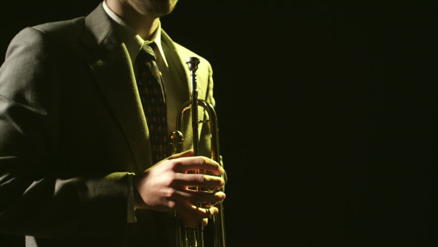 A young saxophonist plays his instrument.