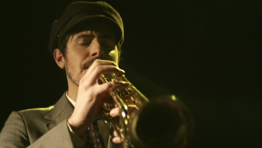 A young saxophonist plays his instrument. 