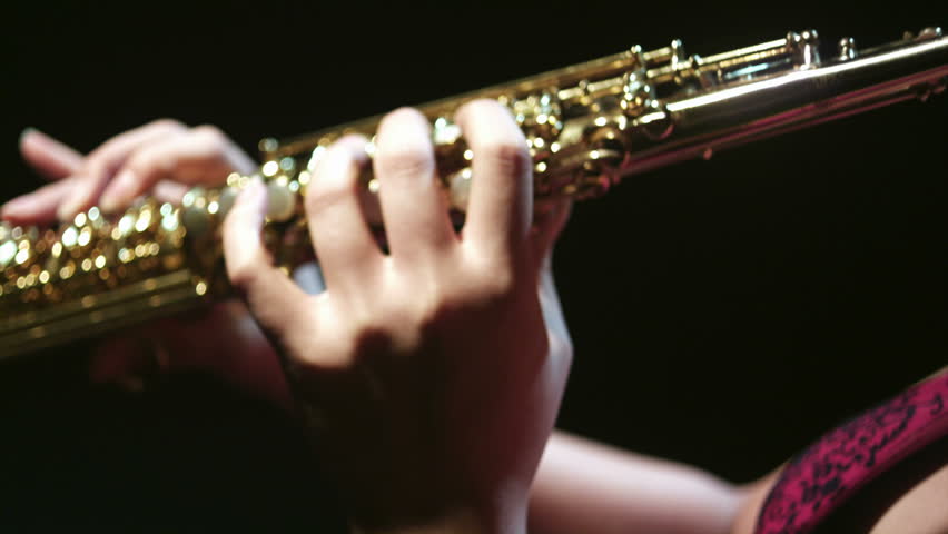 A young trumpeter plays her instrument