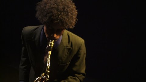 A young saxophonist plays his instrument.  Stock Video