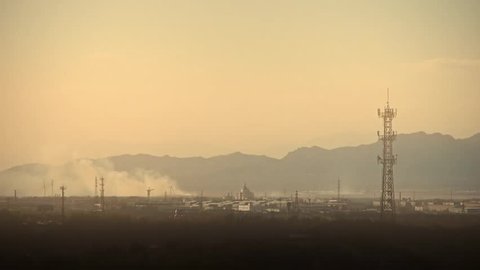 Panoramic of city town & factory smoke rely on mountain,Tower on hill at dusk. gh2_05801
