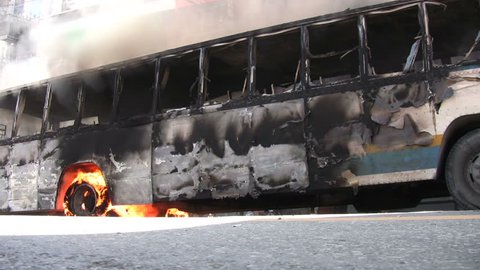 BANGKOK, THAILAND - APRIL 5, 2009: Protesters set buses afire in violent confrontations with government forces 