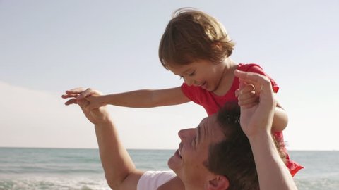 Happy Little Girl On Her Father's Shoulders At Beach. Stockvideo