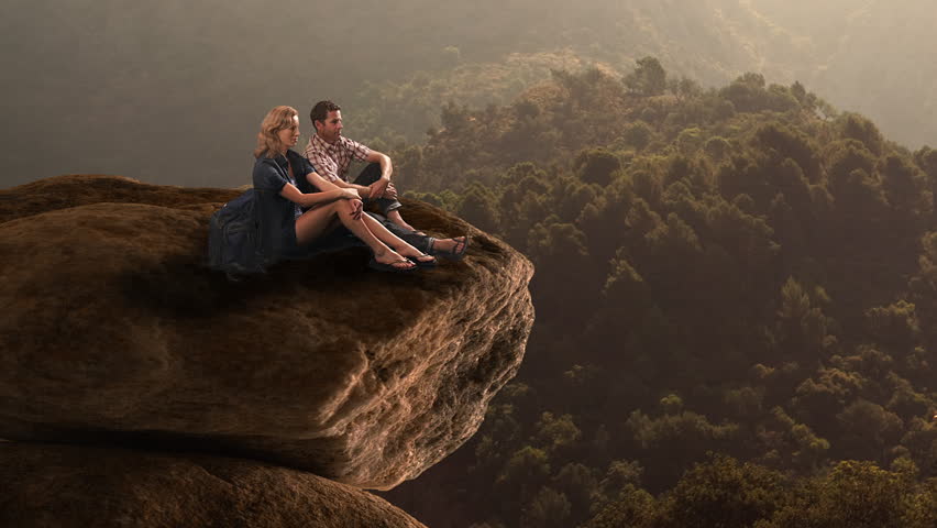 Hikers Resting On Huge Rock In Countryside.