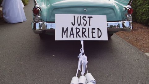 Old time Car with Just Married Sign Cans in Slow Motion