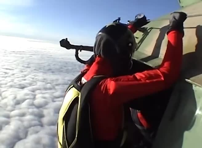 Two skydivers flying above the clouds