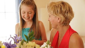 Dolly Shot Of Grandmother And Granddaughter Flower Arranging Together Indoors. - Powered by Shutterstock - Get 15% off with code: PIKWIZARD15