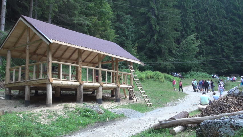 ROMANIA, BUSTENI, AUGUST 30, 2014: Mountain house under construction on a route for tourists. Summer vacation trips.