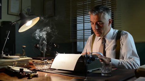 Vintage journalist working late at night at office desk with typewriter and smoking a cigarette.