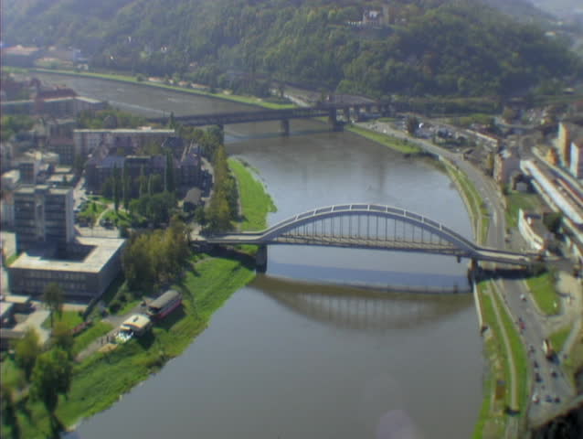River with 2 bridges, traffic driving by