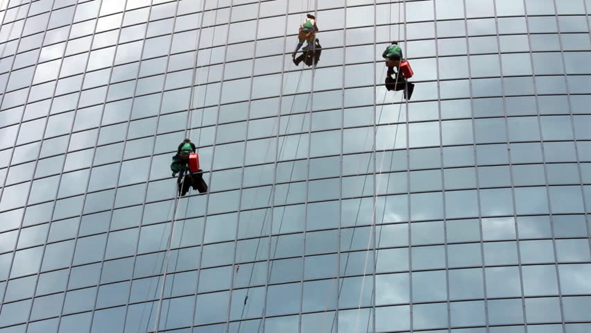 time-lapse with window cleaners at work on skyscraper
