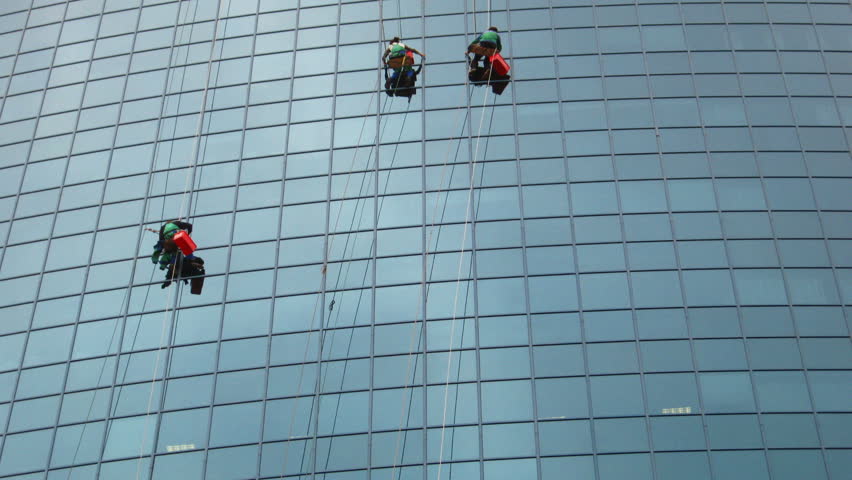 time-lapse with window cleaners at work on skyscraper