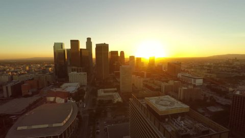 Low flying LA aerial downtown during sunset.
