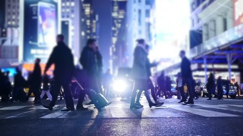 people crossing crosswalk in city. new york city night lights background