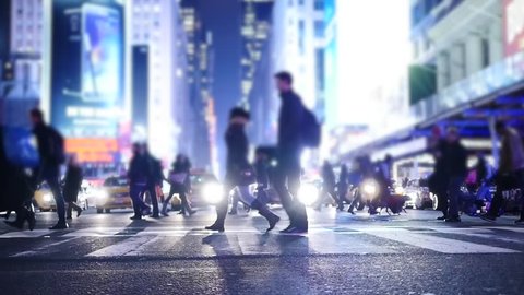 slow motion of pedestrians walking in the city at night. nyc street background