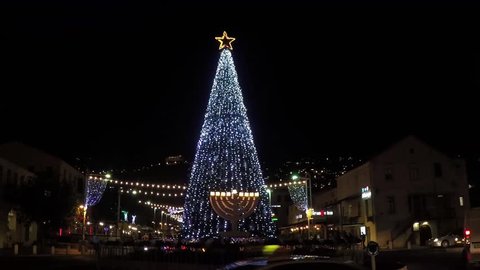 Haifa, Israel - Dec 16, 2014: Christmas tree with neon lights flashing and star on top at Haifa's Ben Gurion blvd. also known as The German colony.