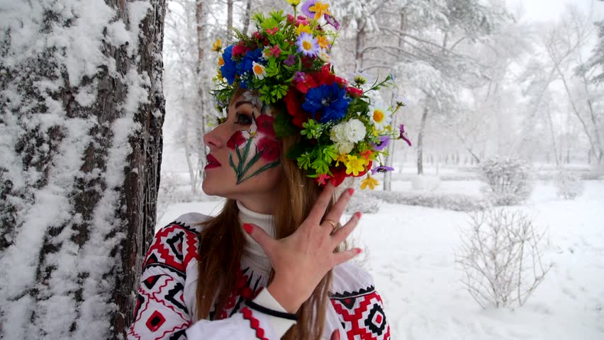 Girl in a winter forest and glad to see snow. Ukraine beauty.
