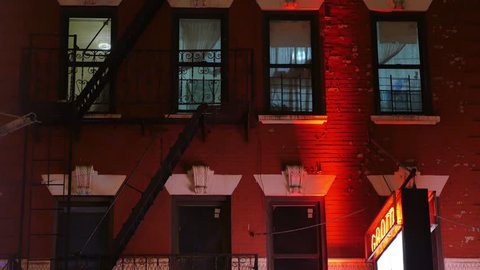 A typical New York City apartment building establishing shot in the night.