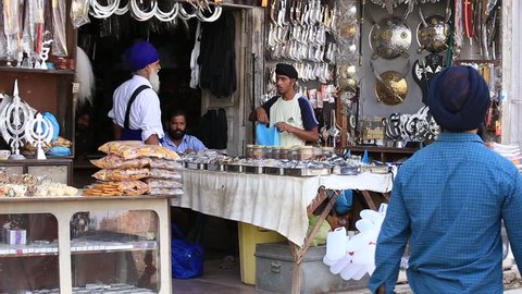  AMRITSAR, INDIA - SEPTEMBER 28, 2014: Unidentified Sikhs and indian people in the gift shop next to the Golden Temple in Amritsar. Sikh pilgrims travel from all over India to pray at this holy site.