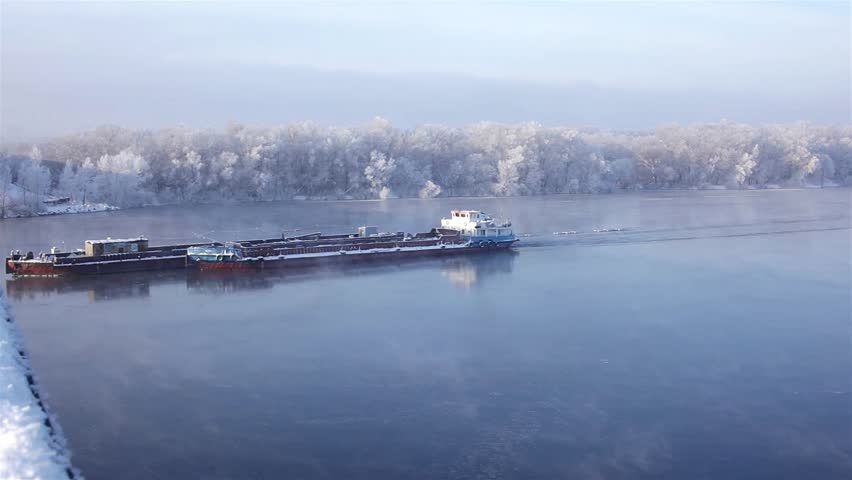 Barge floating on the winter river