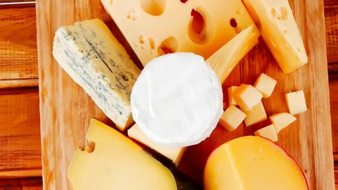 many delicious aged cheeses on wooden plate 1920x1080 intro motion slow hidef hd