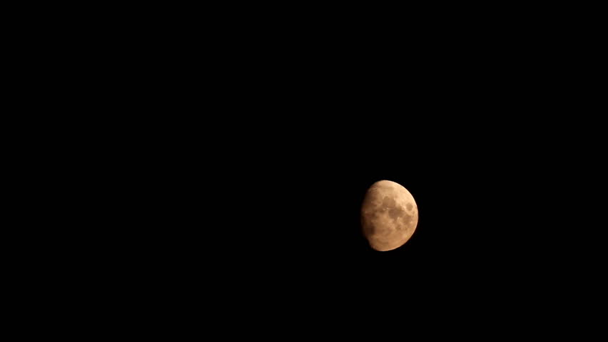 time-lapse with moon moving between clouds