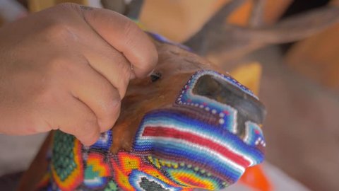 Craftsman making handcraft with colorful beads in 4k