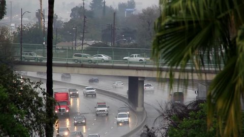 Traffic moving on freeway during heavy rain