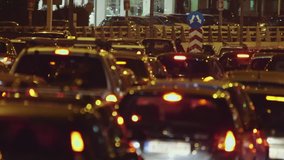 A compilation of car traffic jam real time clips taken at night at a busy avenue in Athens,Greece using a long lens.Due to Christmas working shop hours employees retuning home cause a traffic jam.
