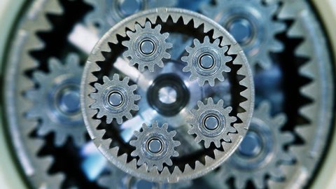 Movement of metal gears in a mechanical device. Brass pinion mechanism. Closeup