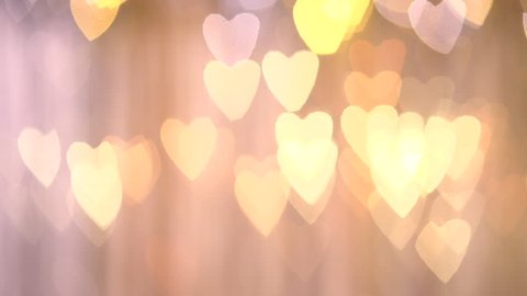 abstract motion background. golden bokeh in the form of heart. HD video footage Vídeo Stock