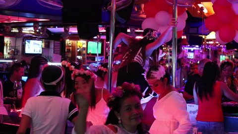 PATTAYA, THAILAND - NOVEMBER 15, 2014: Walking Street is red-light district with many restaurants, go-go bars and brothels, that draws people, primarily for night life and sexual entertainments