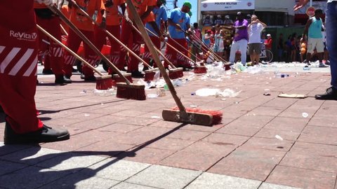 SALVADOR, BRAZIL - MARCH 5, 2014: Group of sweepers arrive to clean up after the end of carnival in Barra.
