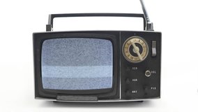 4k stopmotion of very stylish vintage portable television with static on the screen
