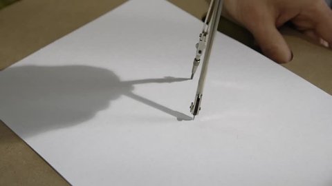 Drawing a circle with a compass close up